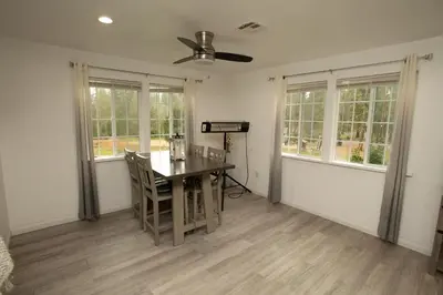 a dining room with a table and chairs and windows at Yosemite Gateway home in Groveland in Groveland