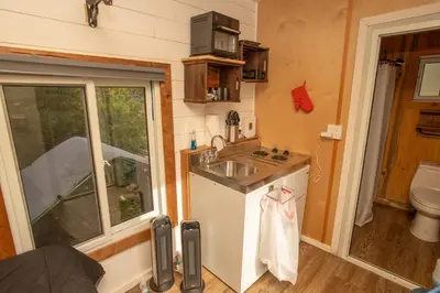 a tiny kitchen with a sink and a toilet at Tiny one house at Yosemite Gateway in Groveland