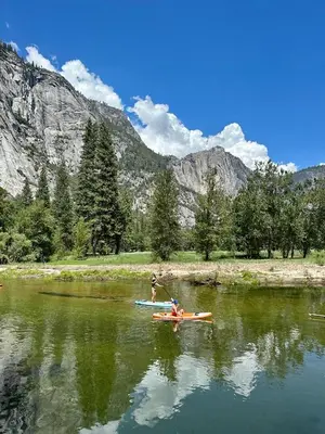 a couple of people are in a kayak on a lake at Tiny one house at Yosemite Gateway in Groveland