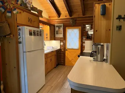 a kitchen with a white refrigerator and a counter top at 45R Camp Duke in North Wawona