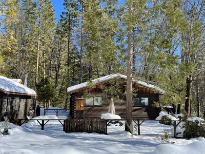 a cabin in the woods in the snow at 45R Camp Duke in North Wawona
