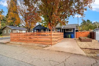 a wooden fence in front of a house at Vintage Vine House in Murphys