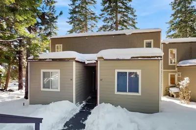 a house with snow on the side of it at Fireside at Tahoe City in Tahoe City