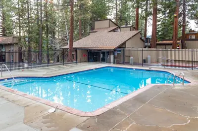 a swimming pool in a yard with a fence at Fireside at Tahoe City in Tahoe City