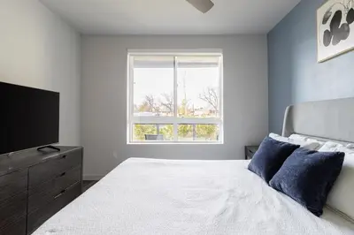 a bedroom with a bed and a flat screen tv at Landing Modern 1BD Clubhouse Courtyard in Reno