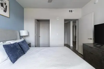 a bedroom with a large bed and a television at Landing Modern 1BD Clubhouse Courtyard in Reno