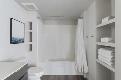 a white bathroom with a tub and a toilet at Landing Modern 1BD Clubhouse Courtyard in Reno