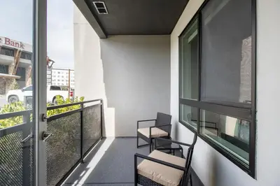 a balcony with two chairs and a glass door at Landing Modern 1BD Clubhouse Courtyard in Reno