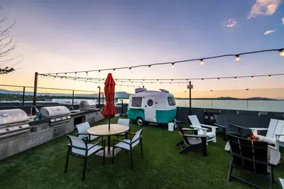 a patio with a table and chairs and a trailer at Landing Modern 1BD Clubhouse Courtyard in Reno
