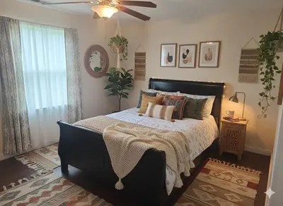 a bedroom with a large bed and a ceiling fan at 3BR 2B Boho Retreat with meditation room in Modesto