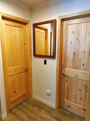 a hallway with two wooden doors and a mirror at Tahoe Thunderbird Suite with Fireplace in South Lake Tahoe