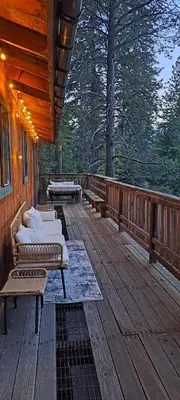 a porch with couches on a wooden deck at Tahoe Thunderbird Suite with Fireplace in South Lake Tahoe