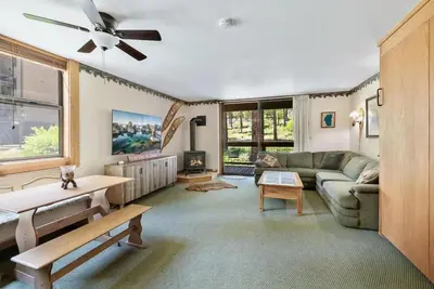 a living room with a couch and a table at Northstar Studio near village and slopes in Truckee