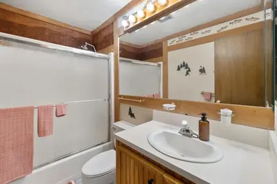 a bathroom with a sink and a toilet and a mirror at Northstar Studio near village and slopes in Truckee