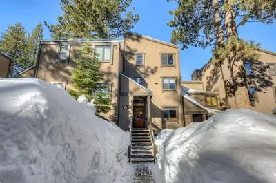 a house with a pile of snow in front of it at Northstar Studio near village and slopes in Truckee