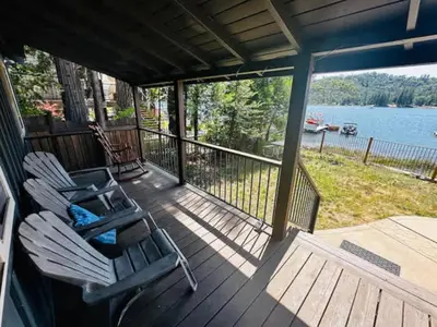 a porch with chairs and a view of the water at Boat Dock - Lake Front - Dog Friendly - Sleeps 23 in Bass Lake