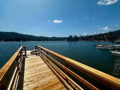 a wooden bridge over a large body of water at Boat Dock - Lake Front - Dog Friendly - Sleeps 23 in Bass Lake