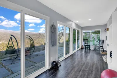 a living room with sliding glass doors and a balcony at Yosemite Retreat, Views and Hot Tub in Oakhurst