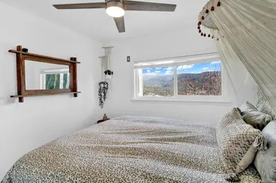 a bedroom with a bed and a window at Yosemite Retreat, Views and Hot Tub in Oakhurst