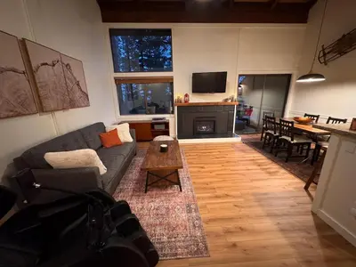a living room with a couch and a table at Newly Remodeled 2Bd 2Ba Condo in NorthStar in Truckee