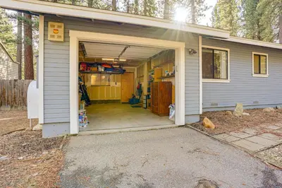 a garage with a door open in a house at 5 Mi to Heavenly Resort Cozy Home with Fenced Yard in South Lake Tahoe