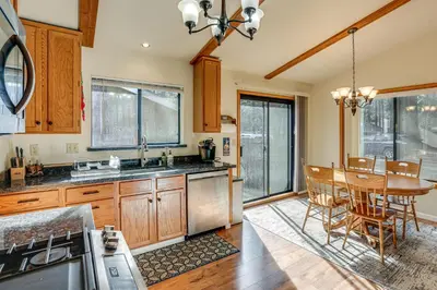 a kitchen with a table and a dining room at 5 Mi to Heavenly Resort Cozy Home with Fenced Yard in South Lake Tahoe
