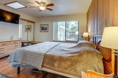 a bedroom with a bed and a dresser and a window at 5 Mi to Heavenly Resort Cozy Home with Fenced Yard in South Lake Tahoe