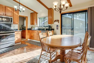 a kitchen with a wooden table and chairs in it at 5 Mi to Heavenly Resort Cozy Home with Fenced Yard in South Lake Tahoe