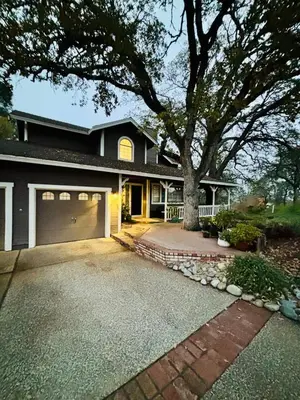 a house with a tree and a driveway at Canyon Ridge Retreat in Folsom