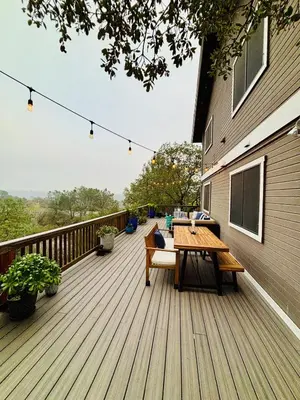 a wooden deck with a table and chairs on it at Canyon Ridge Retreat in Folsom
