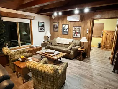a living room with couches and a table at Twain Harte Cozy cabin downtown in Twain Harte