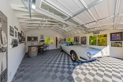 a garage with a car parked in it at Skyfalls Retreat Mid-Century Guesthouse near Yosemite in Oakhurst