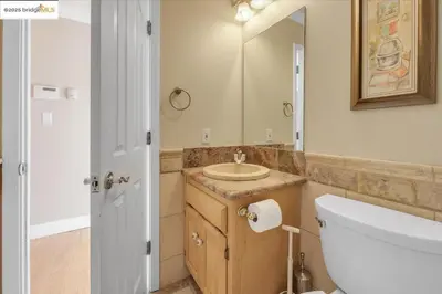 a bathroom with a sink and a toilet and a mirror at 7 br Mega home near Yosemite Spacious, Game Room in Groveland