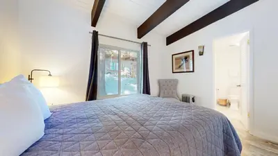 a bedroom with a large bed and a window at Chateau Doex #8 condo in Mammoth Lakes