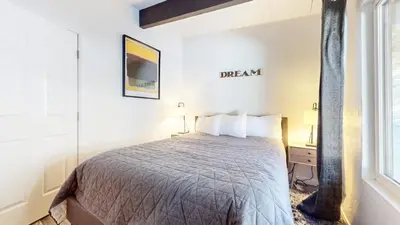 a bedroom with a bed and a window at Chateau Doex #8 condo in Mammoth Lakes