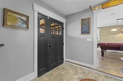 a hallway with a black door and a piano at Lakeview Luxury Retreat with Hot Tub and Game Room in Carnelian Bay