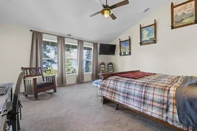 a bedroom with a bed and a ceiling fan at Lakeview Luxury Retreat with Hot Tub and Game Room in Carnelian Bay