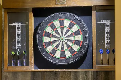 a dart board on a wall with some darts at Lakeview Luxury Retreat with Hot Tub and Game Room in Carnelian Bay