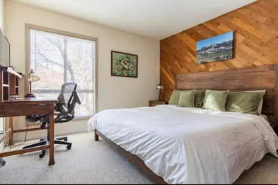 a bedroom with a bed and a desk and a computer at Forest Meadows 8 in Mammoth Lakes
