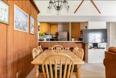 a kitchen with a wooden dining room table and chairs at Forest Meadows 8 in Mammoth Lakes