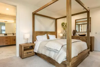 a bedroom with a large bed with a large mirror at Obsidian 104 in Mammoth Lakes