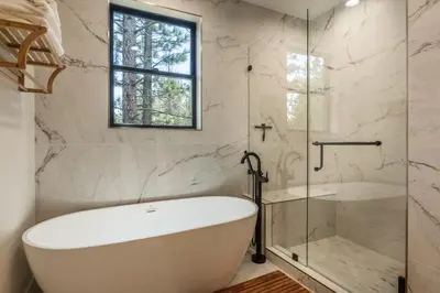 a white bath tub in a bathroom with a window at Obsidian 104 in Mammoth Lakes