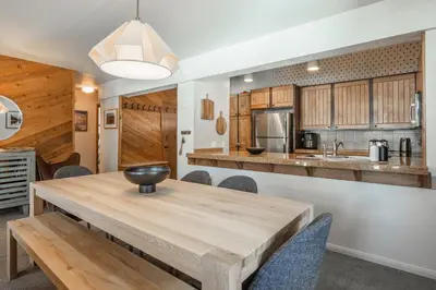 a kitchen and dining room with a wooden table and chairs at Mammoth Creek 36 in Mammoth Lakes