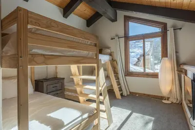 a bedroom with two bunk beds and a window at Mammoth Creek 36 in Mammoth Lakes