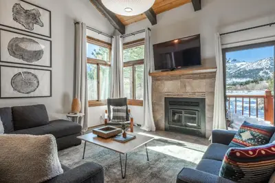 a living room with a fireplace and a tv at Mammoth Creek 36 in Mammoth Lakes