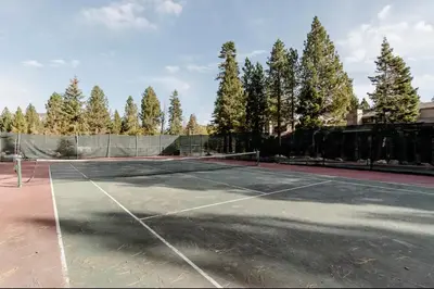 a tennis court with trees in the background at Summit 240 in Mammoth Lakes
