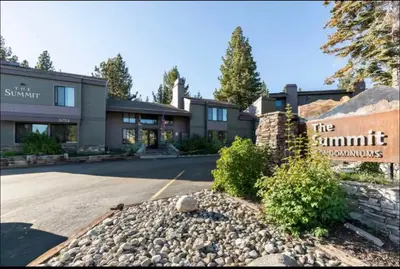 a building with a sign for the summit inn at Summit 240 in Mammoth Lakes