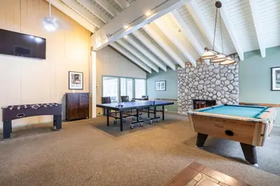 a large room with two ping pong tables in it at Discovery Four 109 in Mammoth Lakes