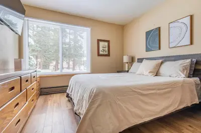 a bedroom with a large bed and a window at Discovery Four 109 in Mammoth Lakes
