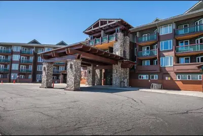 a large apartment building with a parking lot in front of it at Juniper Springs Lodge 437 in Mammoth Lakes